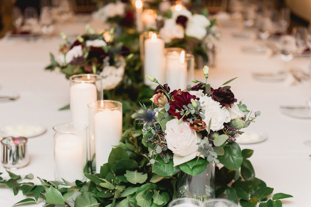 This weddings palette was traditional while still being dynamic. Ivories and burgundies were offset with dusty blue thistles, deep plum ranunculus, and dusty rose lisianthus.