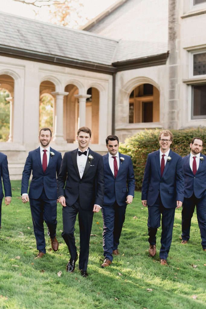 Groom and groomsmen for fall wedding with simple ivory rose boutonnieres.