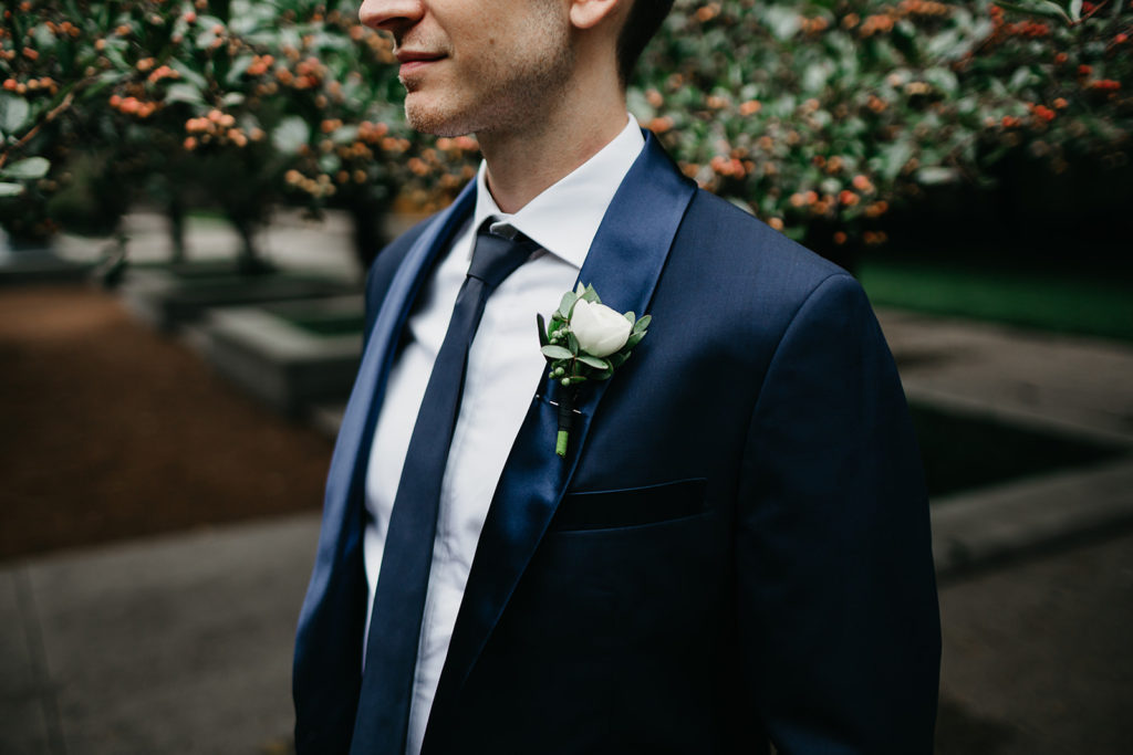 Simple and classic boutonniere of white ranunculus and eucalyptus for a chic outdoor ceremony at Bridgeport Art Center.