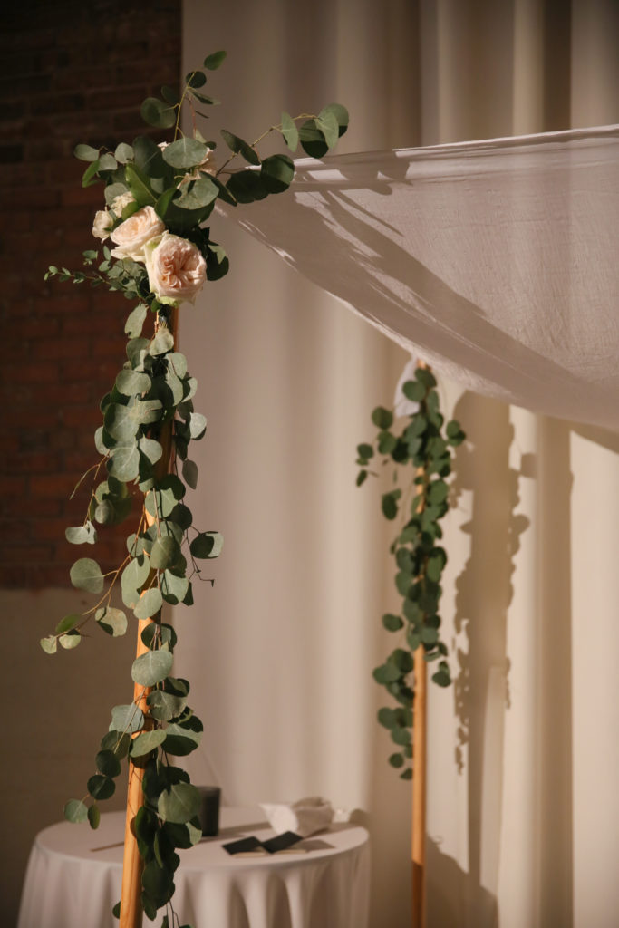 An elegant, minimal chuppah with eucalyptus and garden roses at Artifact Events for a fall wedding in Chicago. Cafe lights, high ceilings, and exposed brick gave an urban romantic environment. 