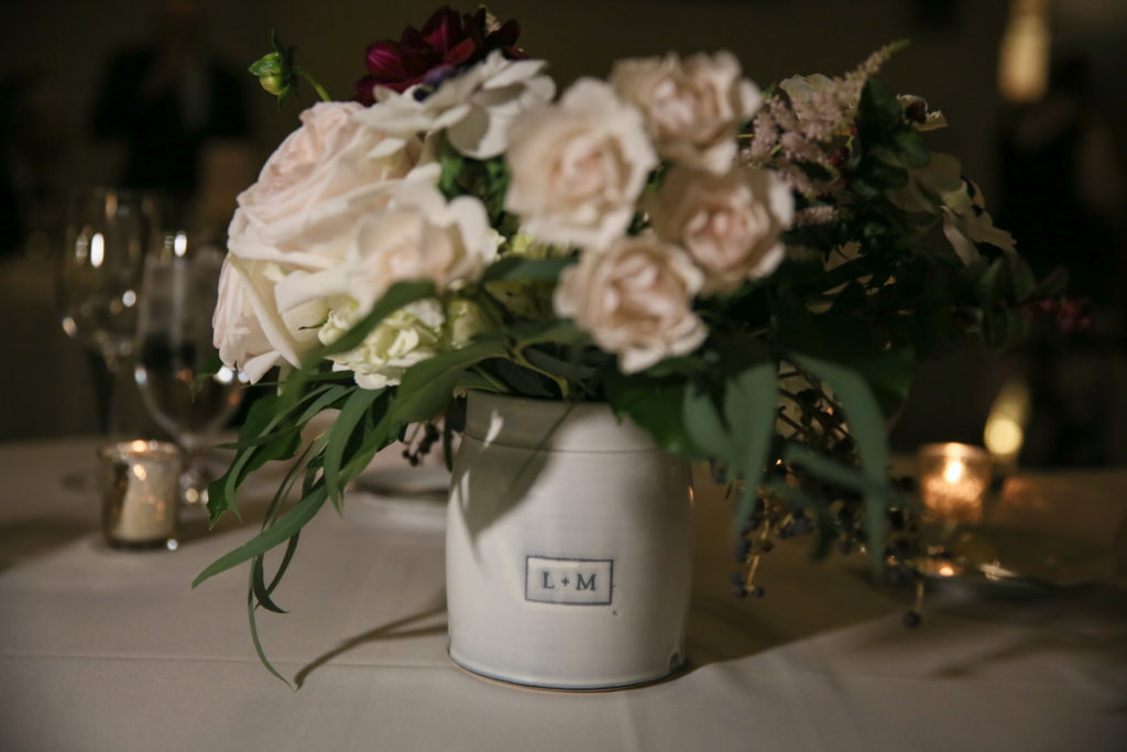 Handmade custom ceramic vase with wedding flowers centerpiece.