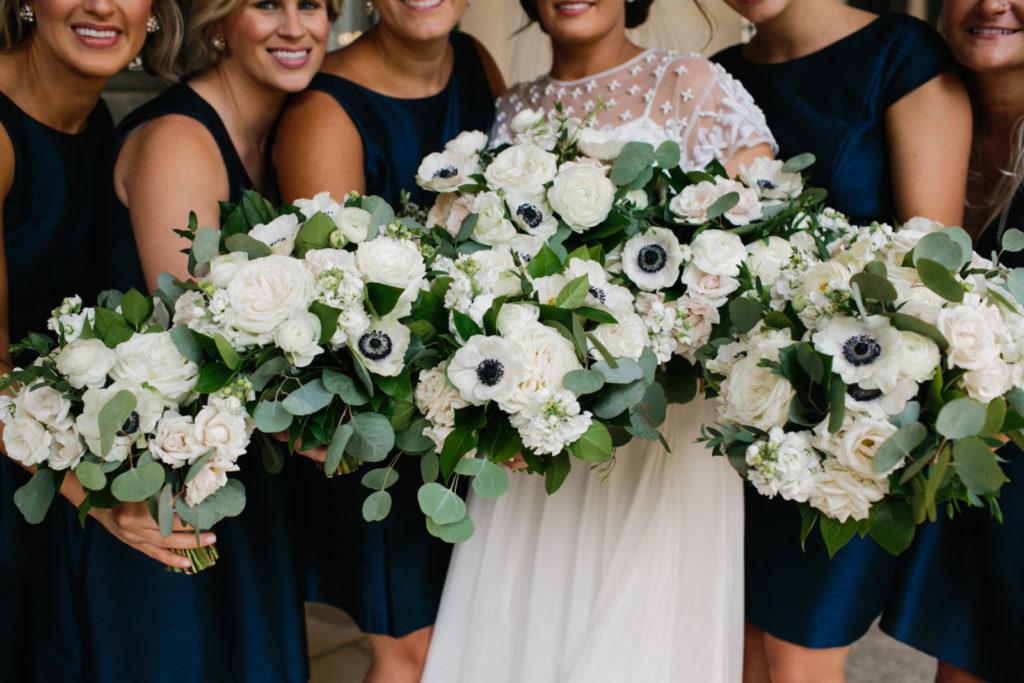 The bride’s bouquet of delicate starry clematis, white anemone, lisianthus, garden roses, and ranunculus. ???