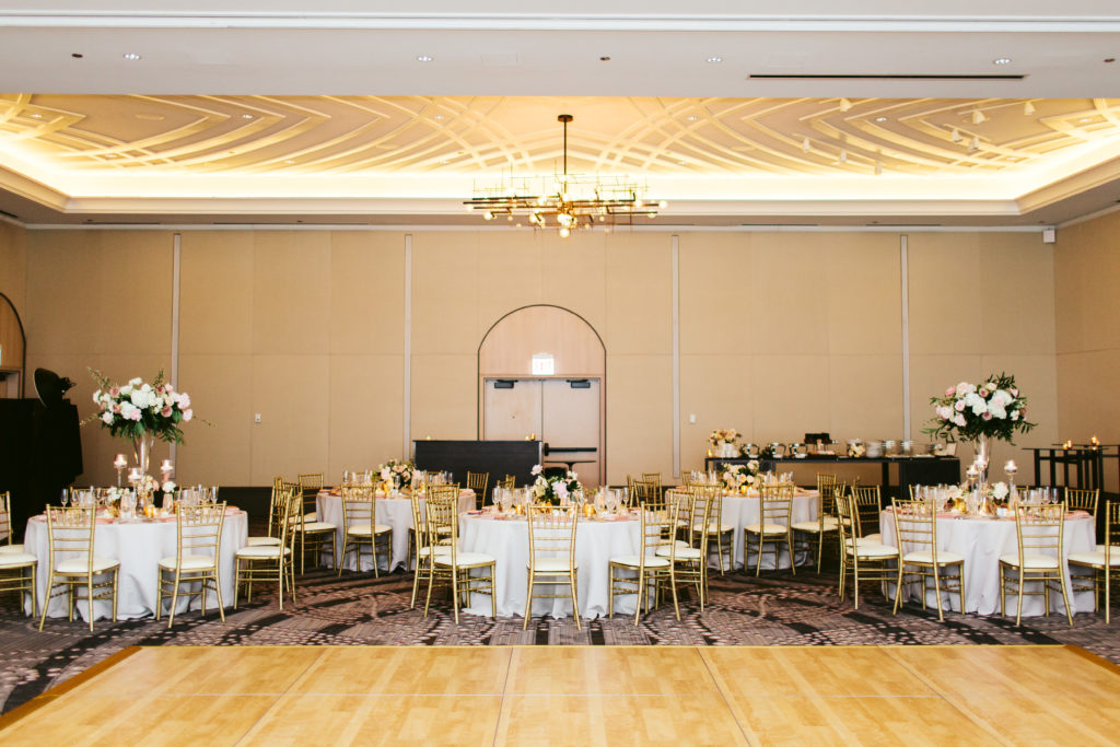 Londonhouse Chicago wedding reception with a mix of tall and low table arrangements of garden roses, peonies, and flowering branches.